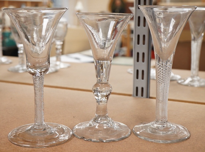 Three 18th century trumpet glasses, two with air twist stems (one with folded foot), together with another with a knopped stem and tear, tallest 16.5cm high